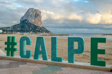 CALPE, SPAIN - JANUARY 24, 2022: Sign in Calpe with the name of the city, with the beach in the background, Alicante province, Valencian Community, Spainのeditorial素材