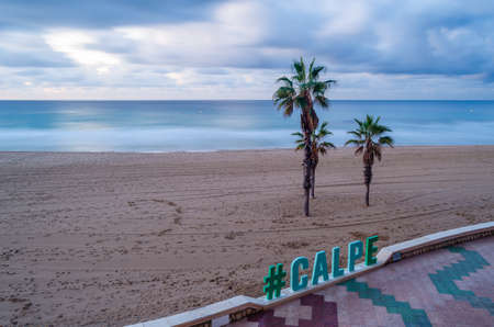 CALPE, SPAIN - JANUARY 24, 2022: Sign in Calpe with the name of the city, with the beach in the background, Alicante province, Valencian Community, Spainのeditorial素材