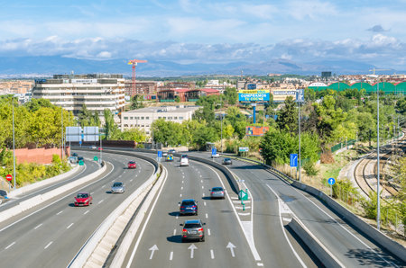 MADRID, SPAIN - SEPTEMBER 26, 2021: View from above of a motorway passing through Madrid, Spain