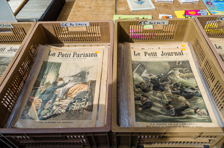 LILLE, FRANCE - AUGUST 17, 2013: Old magazines, books, and miscellaneous items at a flea market at the Vieille Bourse (Old Stock Exchange) in Lille, northern Franceのeditorial素材