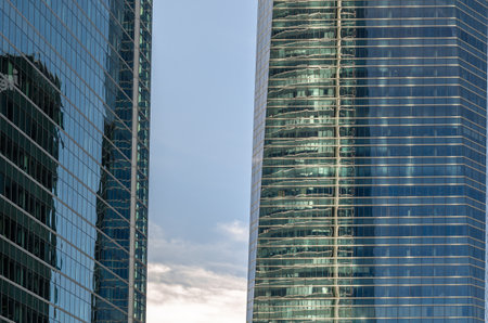 MADRID, SPAIN - OCTOBER 6, 2021: Architectural detail, glass facades of the modern skyscrapers that...