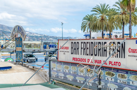 FUENGIROLA, SPAIN - OCTOBER 10, 2021: Advertising signs promoting restaurant in the port area of Fuengirola, located on the Costa del Sol, Andalucia, southern Spainのeditorial素材