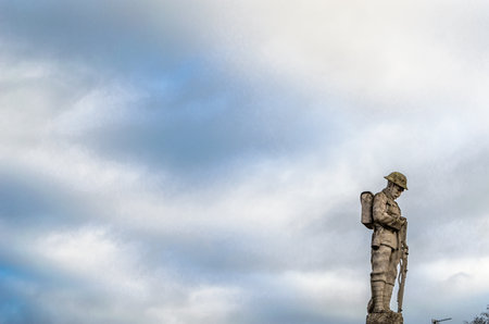 COTTENHAM, ENGLAND, UK - DECEMBER 30, 2013: Statue in the village of Cottenham, Cambridgeshire, England, UK, dedicated to the memory of the men of Cottenham who died in World War I and World War IIのeditorial素材