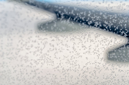 Ice crystals on the window of an airplane in flightの写真素材