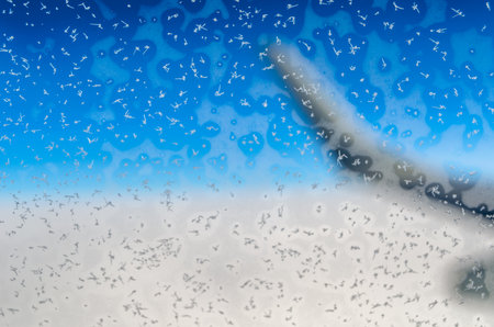 Ice crystals on the window of an airplane in flightの写真素材