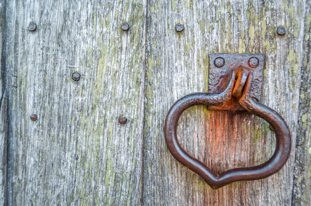 Detail of an old wooden door and a door knockerの写真素材