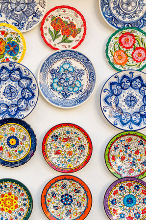 MIJAS, SPAIN - OCTOBER 9, 2021: Typical colorful ceramic plates at a souvenir and handicraft shop in the village of Mijas on the Costa del Sol, Malaga province, Andalusia, southern Spainのeditorial素材