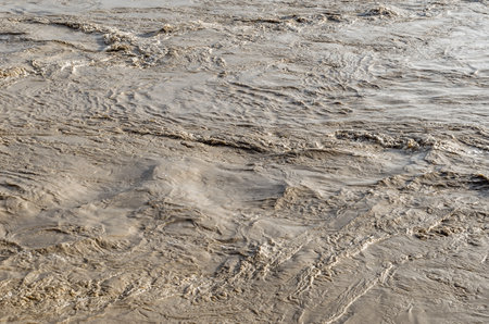 Abstract natural background of muddy turbulent water