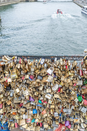 PARIS, FRANCE - JULY 5, 2014: Detail of padlocks as a symbol of love, which decorate a famous bridge...