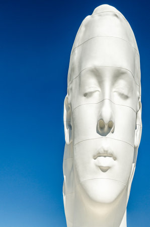 MADRID, SPAIN - JUNE 1, 2019: Sculpture "Julia" made of polyester resin and white marble powder by the artist Jaume Plensa, located since 2018 in the Plaza de Colon in Madrid, Spainのeditorial素材