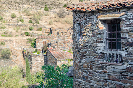 Typical architecture in the town of Patones de Arriba, Spain, one of the most representative examples of so-called black architecture (uses slate as the main construction element, a mineral compound of gray, violet, bluish, brown, silver or blackish tones)の写真素材