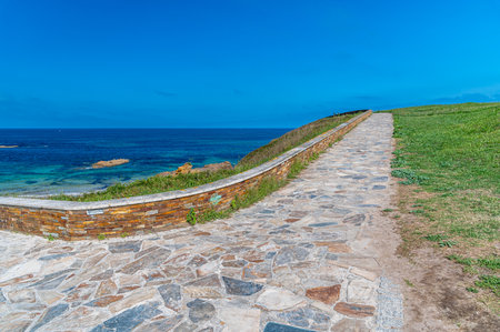 Footpath on the shores of the Cantabrian Sea in the town of Foz, Lugo province, Galicia, northwestern Spainの写真素材
