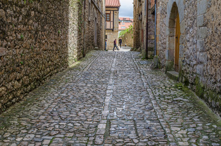 SANTILLANA DEL MAR, SPAIN - MAY 2, 2014: Tourists strolling through narrow streets with stone pavement in the village of Santillana del Mar, Cantabria, northern Spainのeditorial素材