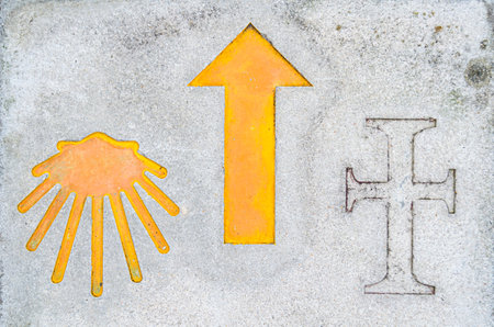 Camino de Santiago (St James Way) symbol (arrow and yellow shell), indicating the directions to...