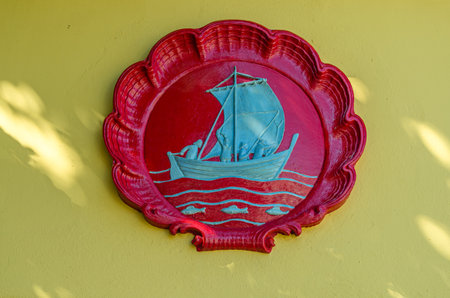 ALESUND, NORWAY - JULY 19, 2014: Coat of arms of the city of Alesund, Norway, on the facade of Aspoy Schoolのeditorial素材