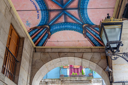 BILBAO, SPAIN - MAY 9, 2014: Urban art on the roofs of the arcades of La Ribera in Bilbao, Basque Country Spain. Detail of the work "The Legend of Kixmi" made by Roberto Zabildea in 1989のeditorial素材