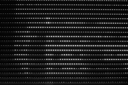Black and white abstract background of light coming through a closed blindの写真素材