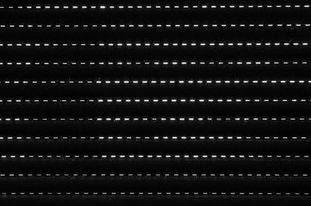 Black and white abstract background of light coming through a closed blindの写真素材