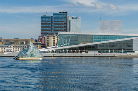 OSLO, NORWAY - JULY 12, 2014: View of the city of Oslo, Norway, from a boat in Oslofjord, with the modern sculpture "She Lies" made by Monica Bonvicini and the Oslo Opera Houseのeditorial素材