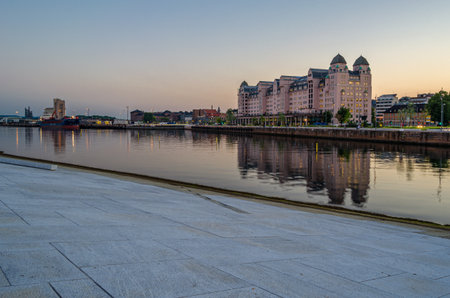 OSLO, NORWAY - JULY 10, 2014: Sunset view of the city of Oslo, Norway, from the modern building of the Oslo Opera House, built between 2003 and 2007, designed by architects from the Norwegian architectural firm Snohettaのeditorial素材