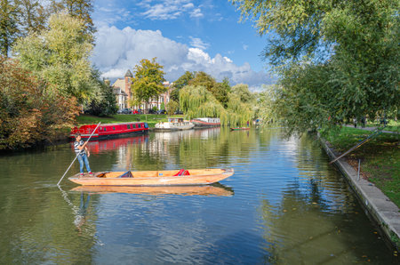 CAMBRIDGE, UK - OCTOBER 11, 2014: Punting on the River Cam in Cambridge, England. A punt is a...