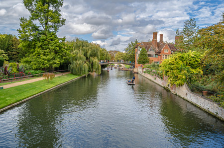 CAMBRIDGE, UK - OCTOBER 11, 2014: Punting on the River Cam in Cambridge, England. A punt is a...