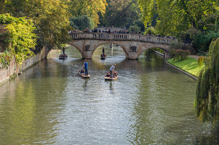 CAMBRIDGE, UK - OCTOBER 11, 2014: Punting on the River Cam in Cambridge, England. A punt is a...