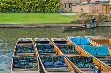CAMBRIDGE, UK - OCTOBER 11, 2014: Punting on the River Cam in Cambridge, England. A punt is a...