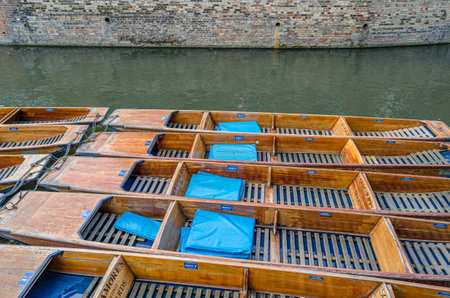 CAMBRIDGE, UNITED KINGDOM - OCTOBER 11, 2014: Punts used for punting on the River Cam in Cambridge,...