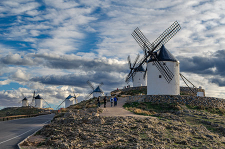 CONSUEGRA, SPAIN - NOVEMBER 16, 2019: Tourists visiting the typical windmills in the village of Consuegra, Toledo province, Castilla la Mancha, Spain, on the famous Don Quixote Routeのeditorial素材