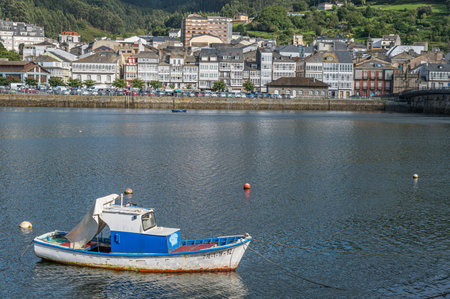 VIVEIRO, SPAIN - SEPTEMBER 2, 2022: View of fishing boats in the port and the old town of Viveiro in the background, Lugo province, Galicia, northwestern Spainのeditorial素材