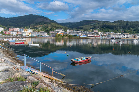 VIVEIRO, SPAIN - SEPTEMBER 2, 2022: View of fishing boats in the port and the old town of Viveiro in...