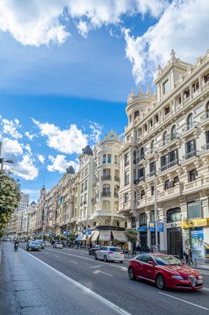 MADRID, SPAIN - APRIL 19, 2015: View of the Gran Via, a street in central Madrid, Spain. The Gran Via serves as a showcase of early 20th-century revival architecture, with architectural styles ranging from Vienna Secession style, Plateresque, Neo-Mudejar のeditorial素材