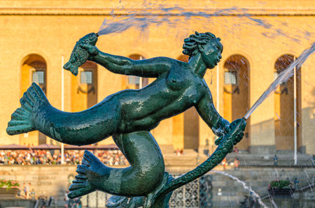 GOTHENBURG, SWEDEN - JULY 9, 2014: Detail of the fountain from the Statue of Poseidon by Carl Milles, inaugurated in 1931, in Gothenburg, Sweden, with the Gothenburg Museum of Art in the backgroundのeditorial素材