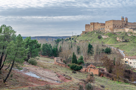 SIGUENZA, SPAIN - DECEMBER 27, 2014: View of the village of Siguenza, Guadalajara province, Castilla la Mancha, Spain, with the medieval Castle of the Bishops of Siguenza in the background, which today is the parador (luxury hotel)のeditorial素材