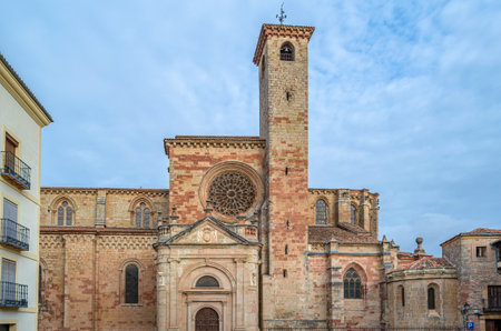 The Cathedral of Santa Maria in Siguenza, built between 1144-1326, Guadalajara province, Castilla la Mancha, Spain. View of the Romanesque-style Market Gate (Puerta del Mercado), covered by a closed Neoclassical portico, built in 1797 and Torre del Gallo のeditorial素材