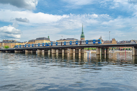 STOCKHOLM, SWEDEN - JULY 27, 2014: Subway train (metrotrain) which is part of Stockholm metro, crossing a bridge in the old town of Stockholm, Swedenのeditorial素材
