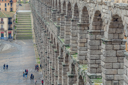 SEGOVIA, SPAIN - DECEMBER 22, 2019: Tourists visiting the famous Roman aqueduct, landmark of Segovia, Castile and Leon, Spainのeditorial素材
