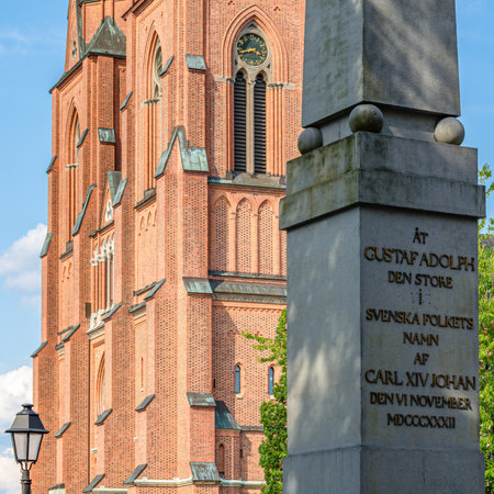 UPPSALA, SWEDEN - JULY 26, 2014: The obelisk designed by Louis Jean Desprez, erected in 1832 in memory of Gustav II Adolf, next to the cathedral of Uppsala, Swedenのeditorial素材