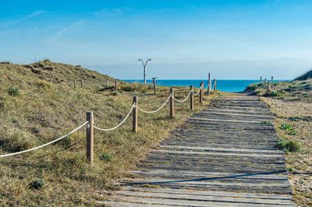 Wooden walkway through the dunes, providing access to Saler Beach (Playa del Saler), Valencia, Spainの写真素材