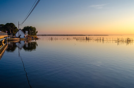 VALENCIA, SPAIN - DECEMBER 28, 2019: People watching a beautiful sunset in Albufera Natural Park, Valencia, Spainのeditorial素材