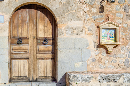 DEIA, SPAIN - JANUARY 10, 2015: Path to the cemetery of the village of Deia, Mallorca, Balearic Islands, Spain, lined with small chapels with scenes from the Stations of the Cross (Via Crucis). Each station was donated and has been maintained by a local fのeditorial素材