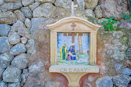 DEIA, SPAIN - JANUARY 10, 2015: Path to the cemetery of the village of Deia, Mallorca, Balearic Islands, Spain, lined with small chapels with scenes from the Stations of the Cross (Via Crucis). Each station was donated and has been maintained by a local fのeditorial素材