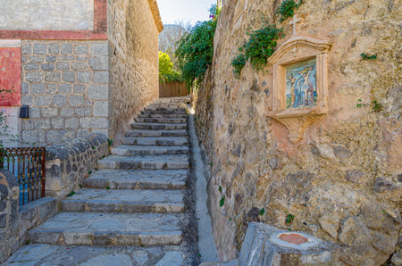 DEIA, SPAIN - JANUARY 10, 2015: Path to the cemetery of the village of Deia, Mallorca, Balearic Islands, Spain, lined with small chapels with scenes from the Stations of the Cross (Via Crucis). Each station was donated and has been maintained by a local fのeditorial素材