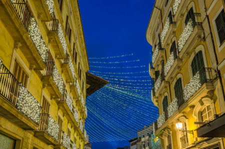 Night view of Plaza de Cort (central square), decorated with festive lights, in the center of Palma, Mallorca, Balearic Islands, Spainの写真素材