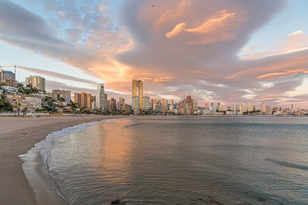 Sunset view of modern buildings in front of Poniente Beach in Benidorm, Alicante province, Valencian Community, Spainの写真素材