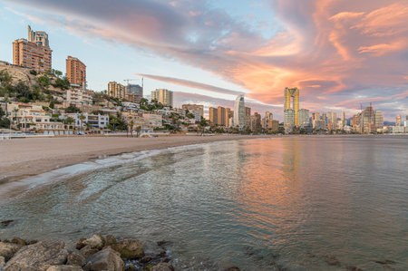 Sunset view of modern buildings in front of Poniente Beach in Benidorm, Alicante province, Valencian Community, Spainの写真素材