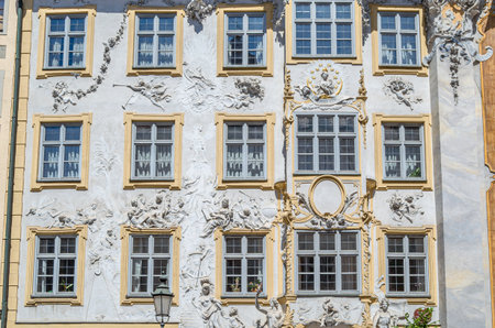 MUNCHEN, GERMANY - JULY 26, 2015: Facade of Asamhaus in Munich, Germany, a 16th-century Baroque residential building acquired by the Asam brothers in 1733, showing white stucco ornamentation on a yellow backgroundのeditorial素材