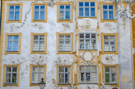 MUNCHEN, GERMANY - JULY 3, 2015: Facade of Asamhaus in Munich, Germany, a 16th-century Baroque residential building acquired by the Asam brothers in 1733, showing white stucco ornamentation on a yellow backgroundのeditorial素材