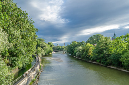 MUNCHEN, GERMANY - JULY 25, 2015: People strolling on the banks of the Isar River in Munich, Germanyのeditorial素材